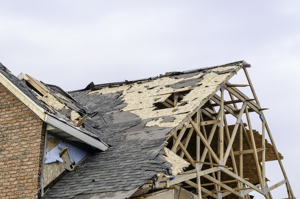 Skeletal remains of peaked roof on house hit by tornado-1